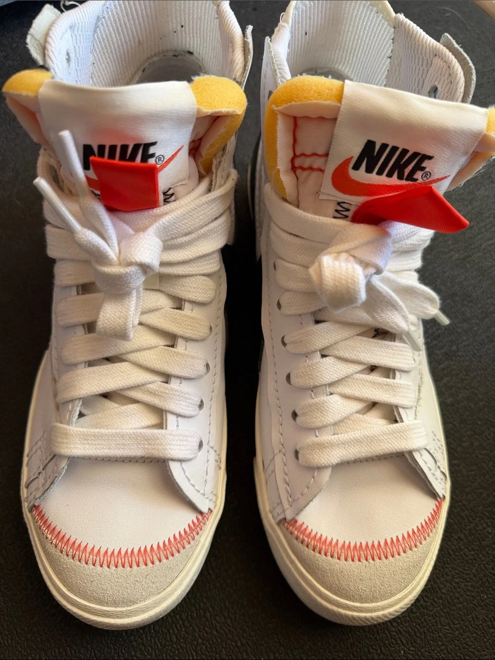 Nike White High-Top Sneakers with Orange and Yellow Accents
